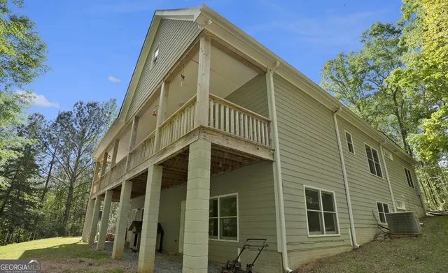 an aerial view of residential houses with outdoor space and trees