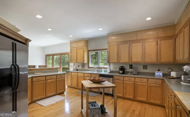 a kitchen with stainless steel appliances a sink a stove and cabinets