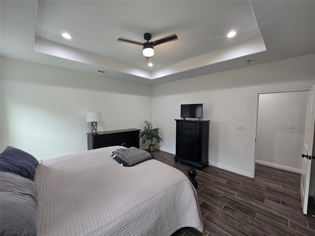109 Baker Street Mount Vernon, TX 75457 - Photo 12 of 20 a bedroom with a bed and a television