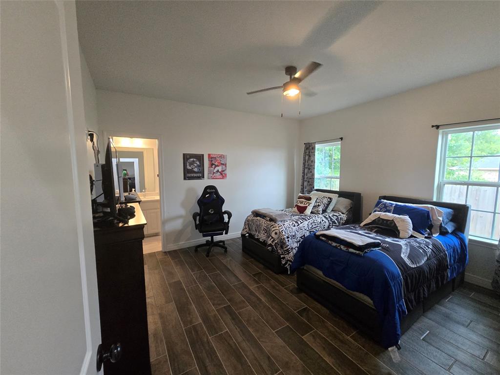 109 Baker Street Mount Vernon, TX 75457 - Photo 14 of 20 a bedroom with two beds and a dresser