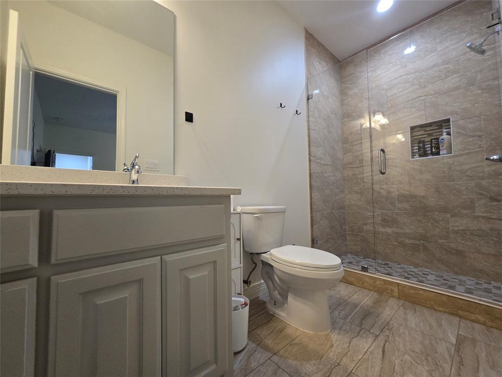 109 Baker Street Mount Vernon, TX 75457 - Photo 15 of 20 a bathroom with a sink toilet and shower