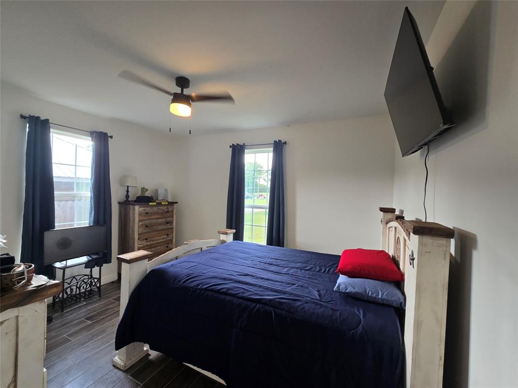 109 Baker Street Mount Vernon, TX 75457 - Photo 17 of 20 a bedroom with a bed and a flat screen tv