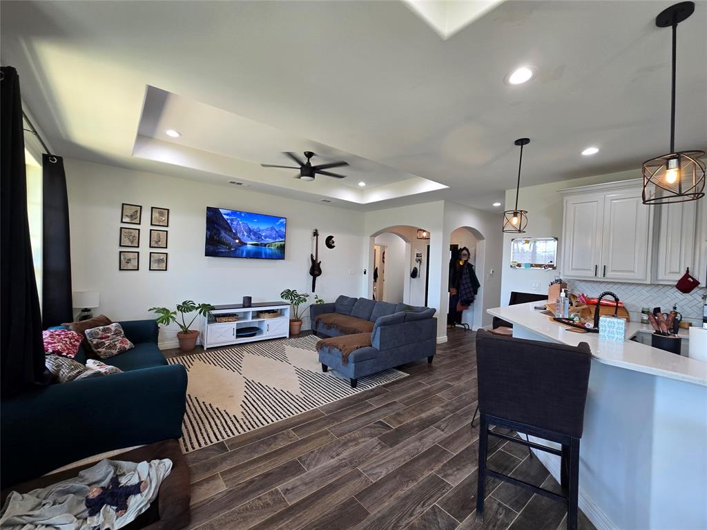 109 Baker Street Mount Vernon, TX 75457 - Photo 7 of 20 a living room with furniture kitchen view and a wooden floor