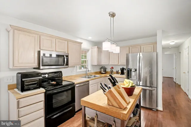 a kitchen with granite countertop a sink and cabinets