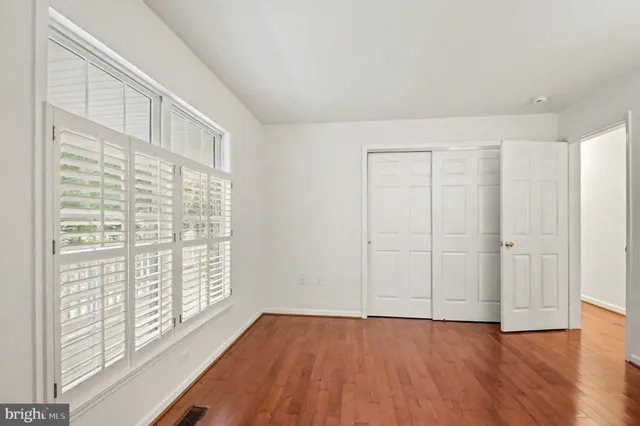 a view of wooden floor and closet in a room