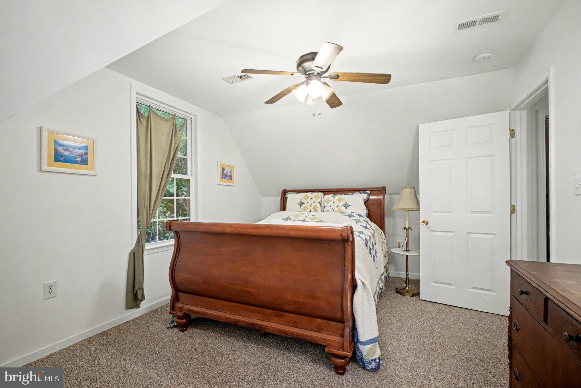 88 Carter Way Montross, VA 22520 - Photo 25 of 68 a bedroom with a bed and a chandelier