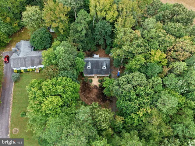 a view of a chair and table in the backyard of the house