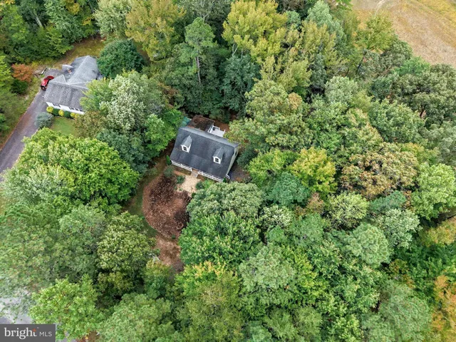 a view of a chair and table in back yard of the house
