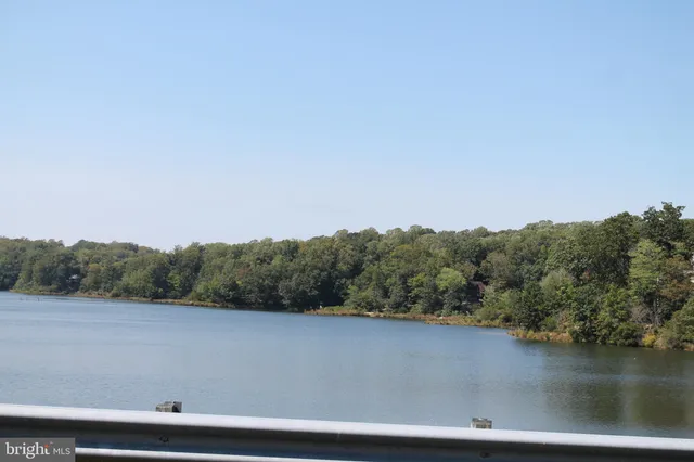 a front view of a house with garden and sitting area