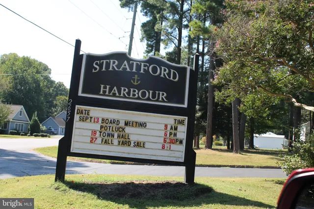 a front view of a house with garden and sitting area