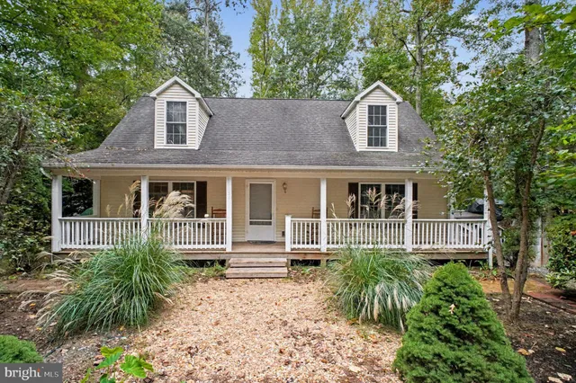 a living room with furniture a flat screen tv and a large window
