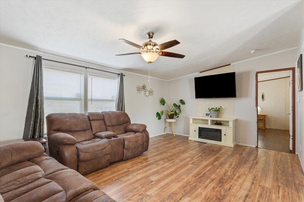 247 North Lake Street Axtell, TX 76624 - Photo 5 of 24 a living room with furniture and a flat screen tv