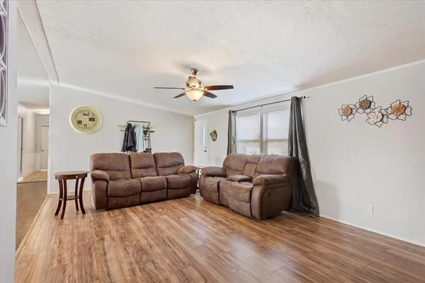 a living room with furniture and wooden floor
