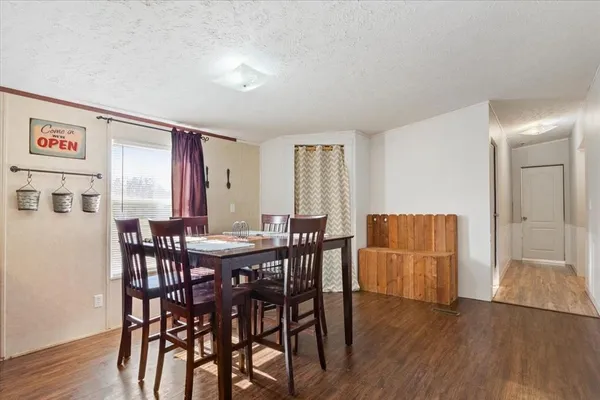 a view of a dining room with furniture and wooden floor