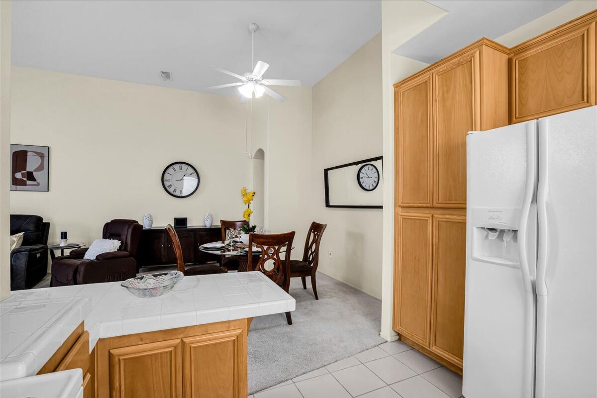 47795 Soft Moonlight La Quinta, CA 92253 - Photo 13 of 44 a kitchen with a refrigerator and table