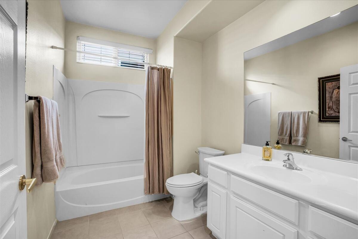 47795 Soft Moonlight La Quinta, CA 92253 - Photo 23 of 44 a bathroom with a granite countertop sink toilet and shower