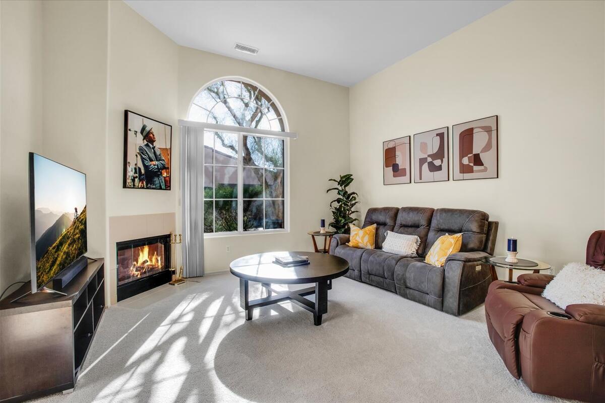 47795 Soft Moonlight La Quinta, CA 92253 - Photo 3 of 44 a living room with furniture a fireplace and a flat screen tv