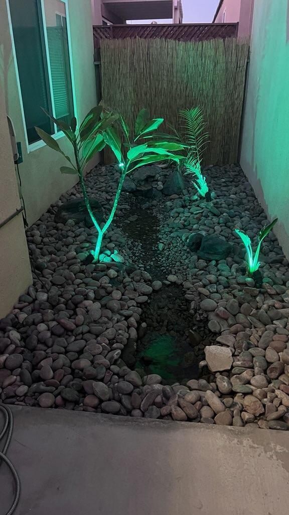 47795 Soft Moonlight La Quinta, CA 92253 - Photo 32 of 44 a backyard of a house with lots of green space and a fountain