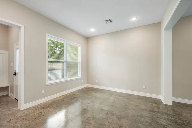 a kitchen with stainless steel appliances a refrigerator a stove top oven and white cabinets