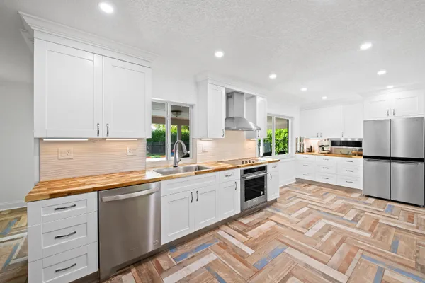 a kitchen with a sink appliances and cabinets