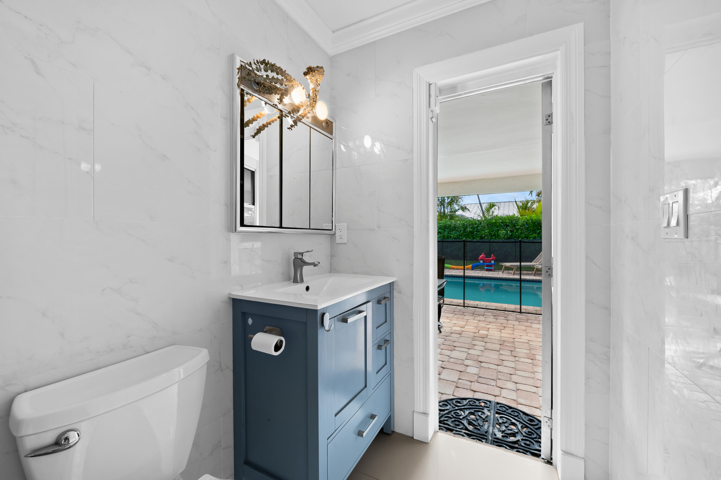 3333 Northwest 26th Court Boca Raton, FL 33434 - Photo 16 of 41 a bathroom with a toilet a sink a vanity and mirror
