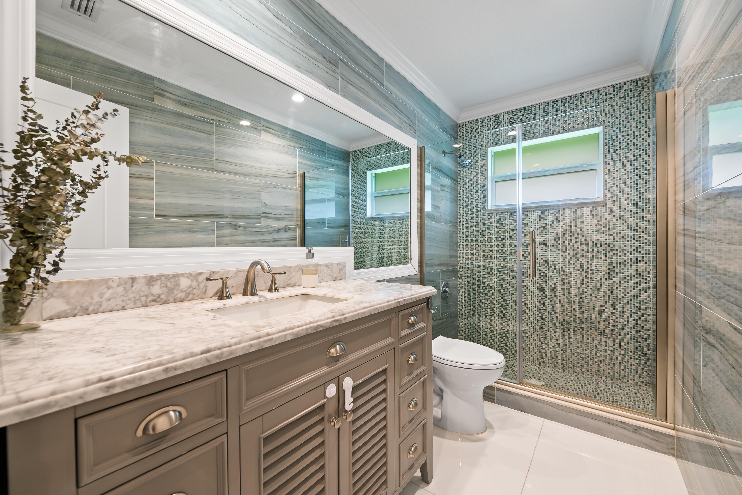 3333 Northwest 26th Court Boca Raton, FL 33434 - Photo 21 of 41 a bathroom with a granite countertop sink toilet and shower