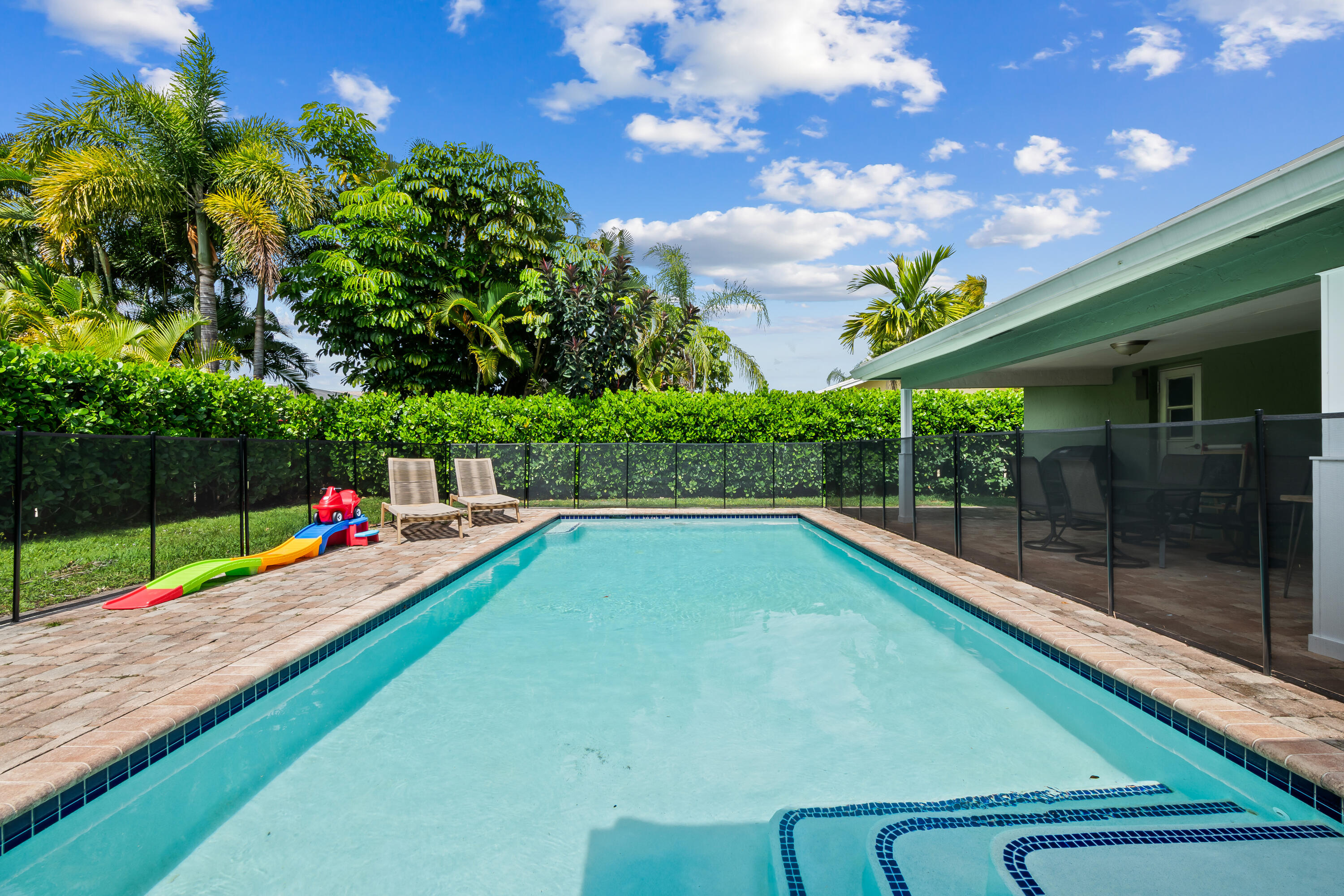 3333 Northwest 26th Court Boca Raton, FL 33434 - Photo 24 of 41 a view of a backyard with swimming pool and seating space