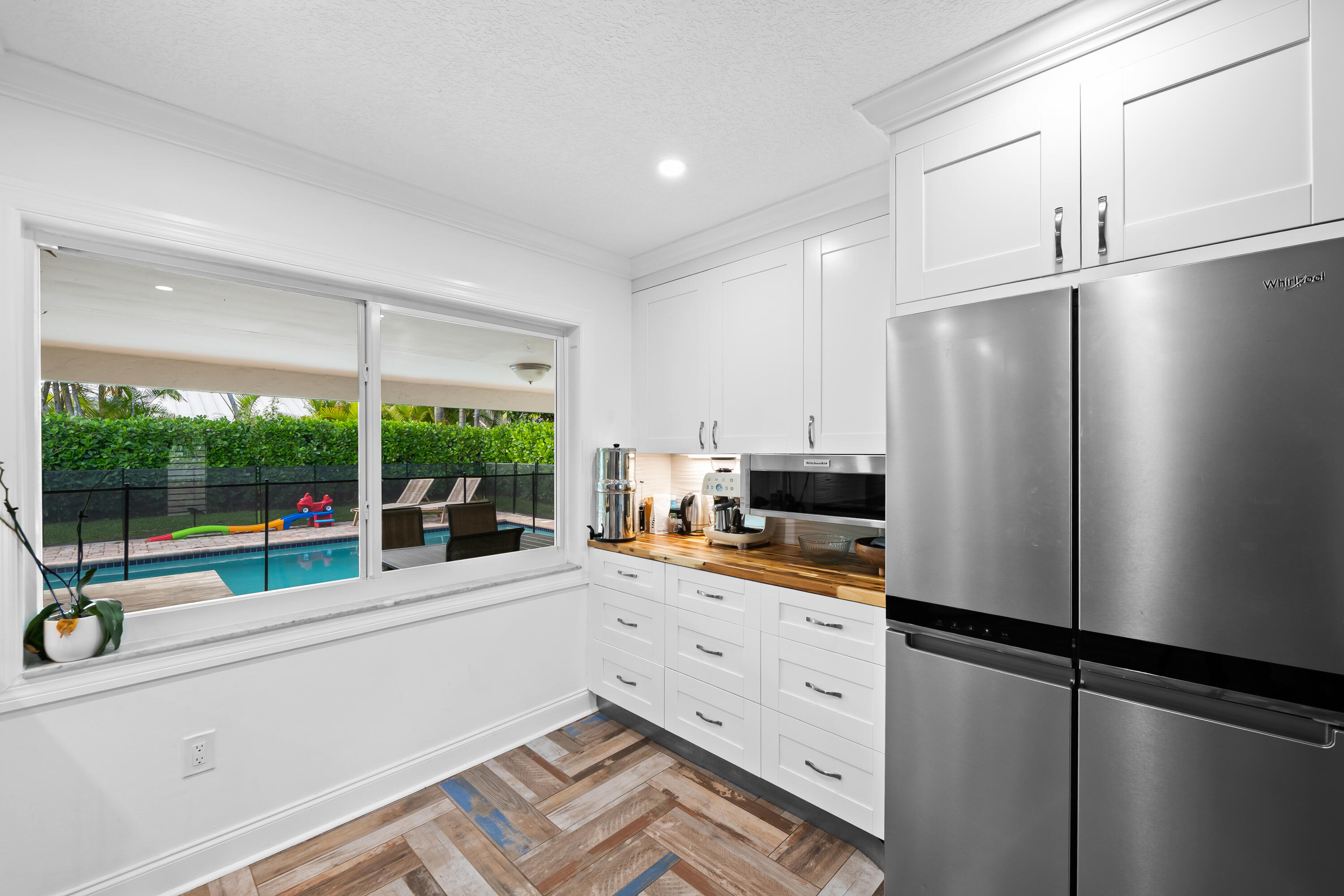 3333 Northwest 26th Court Boca Raton, FL 33434 - Photo 4 of 41 a kitchen with a refrigerator and a large window