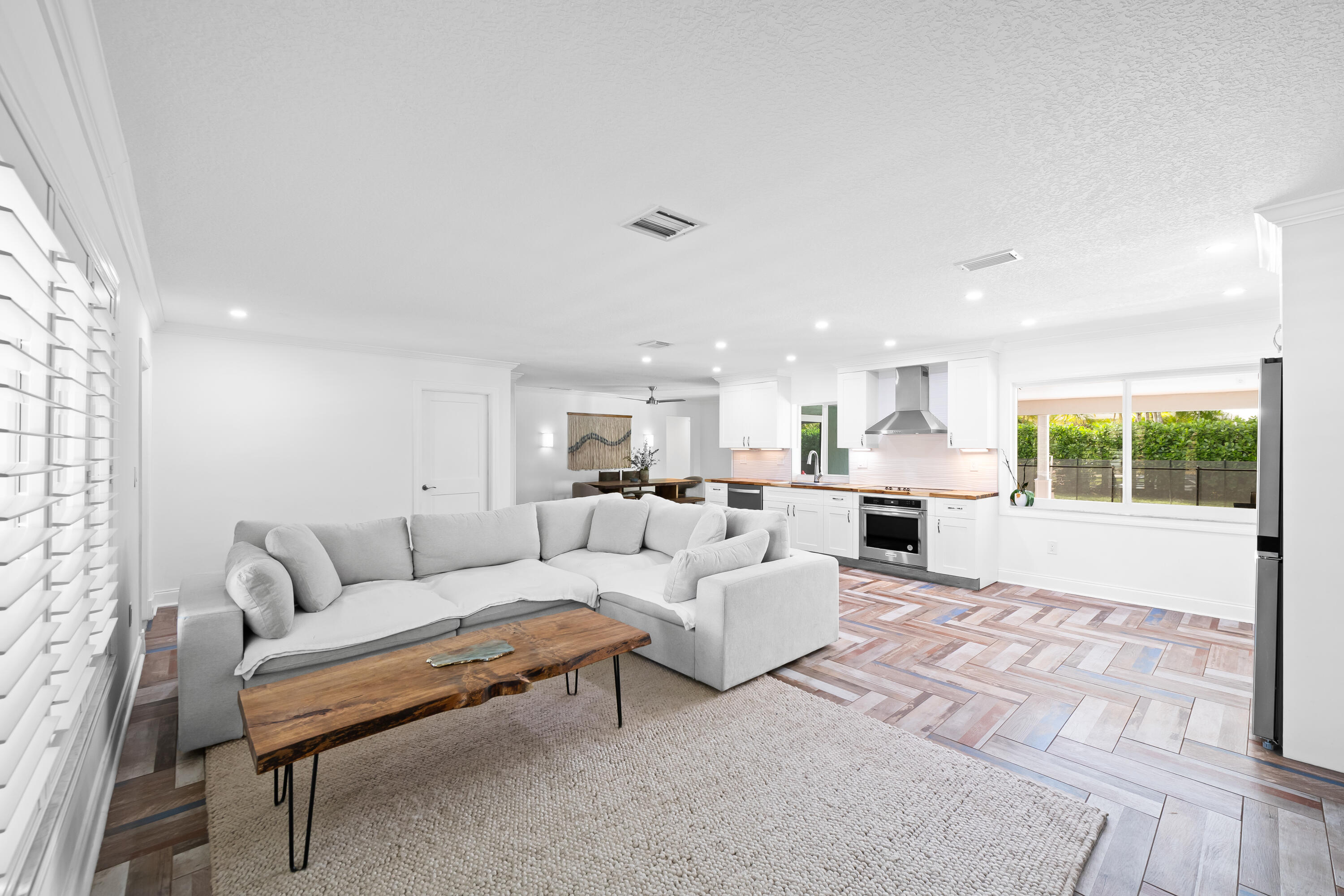 3333 Northwest 26th Court Boca Raton, FL 33434 - Photo 6 of 41 a living room with furniture white walls and a large window