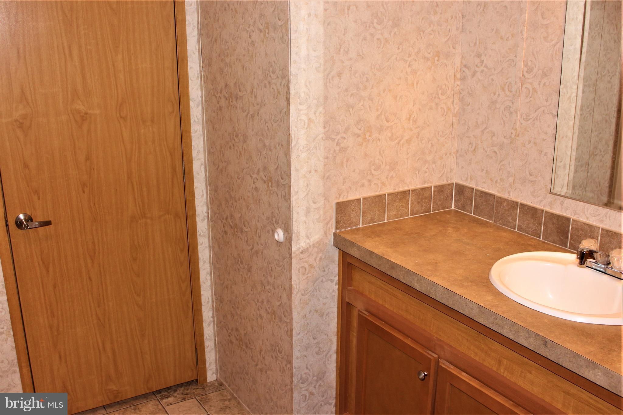28288 Basin Road Millsboro, DE 19966 - Photo 24 of 38 Master bath has large vanity, stall shower.