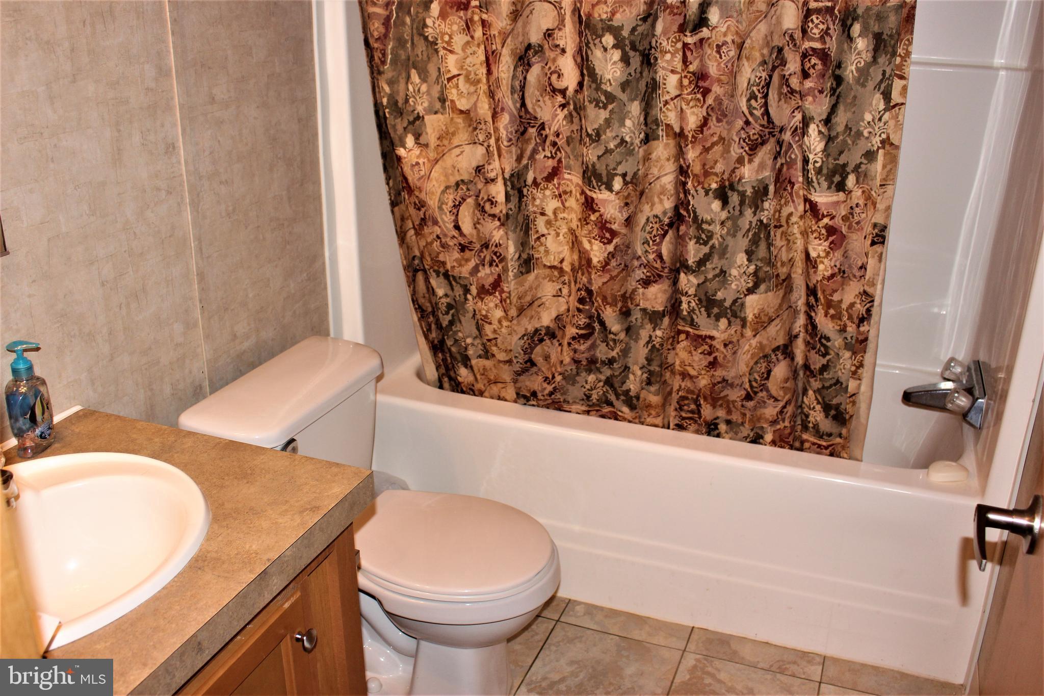 28288 Basin Road Millsboro, DE 19966 - Photo 28 of 38 Hall bathroom with tub / shower combo.