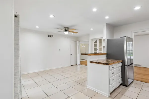 a kitchen with cabinets and wooden floor