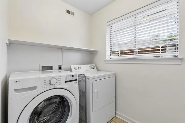 a view of washer and dryer with kitchen in the background