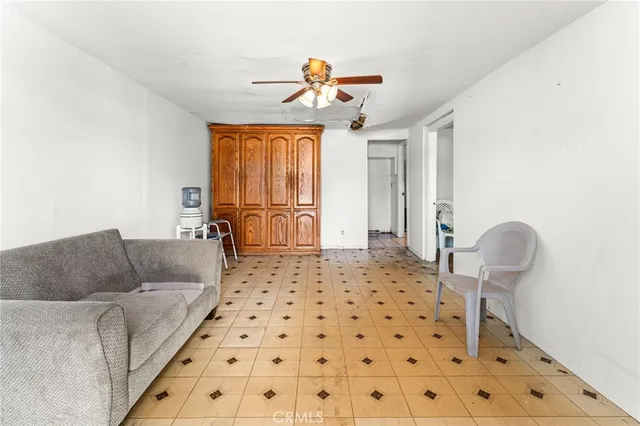 a living room with a couch and a chandelier