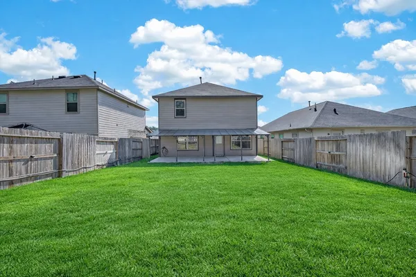 a view of a backyard with wooden fence