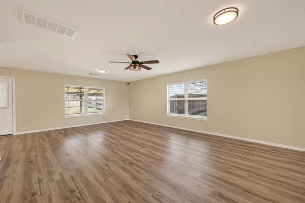wooden floor in an empty room with a window