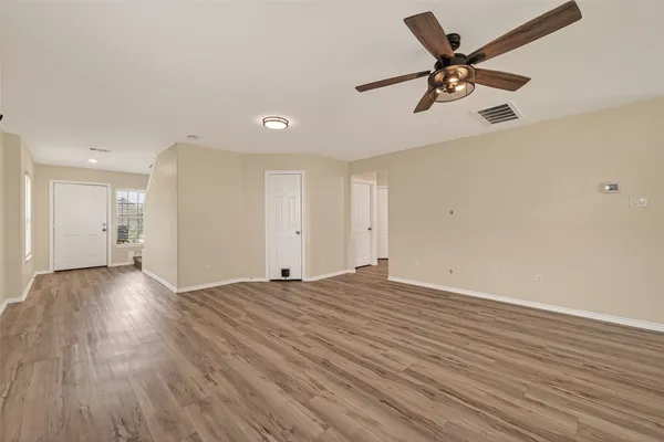 a view of a livingroom with a hardwood floor and a ceiling fan