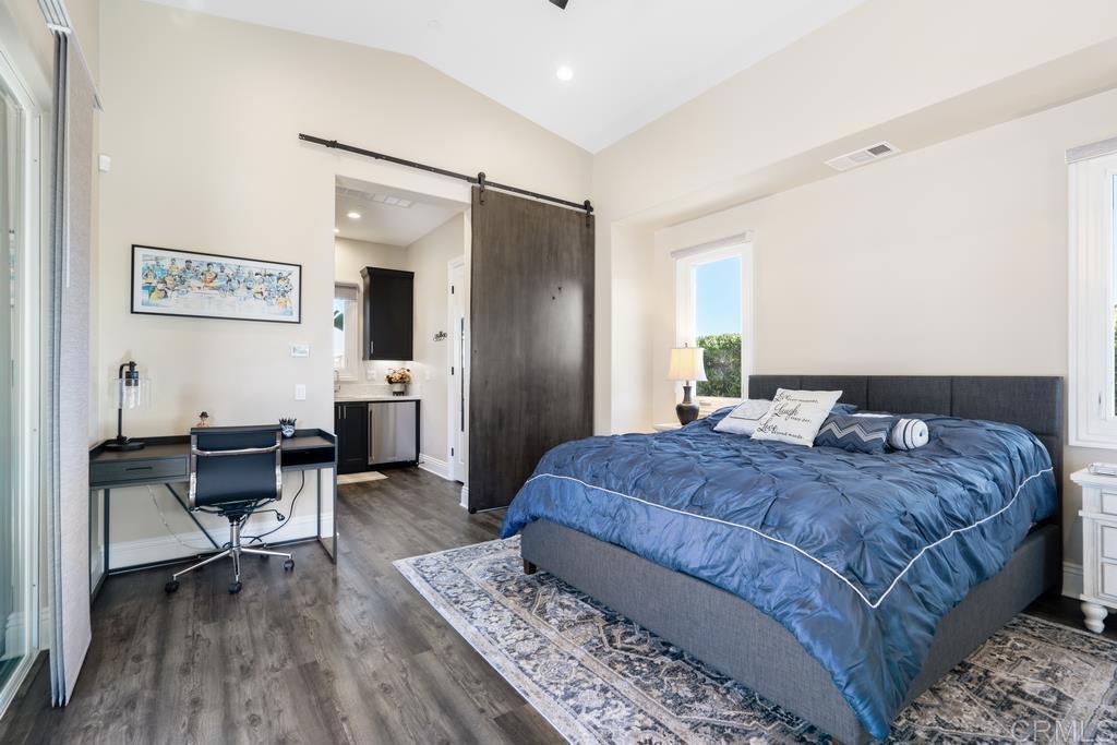 15433 Artesian Ridge San Diego, CA 92127 - Photo 11 of 20 a spacious bedroom with a bed a table and chair