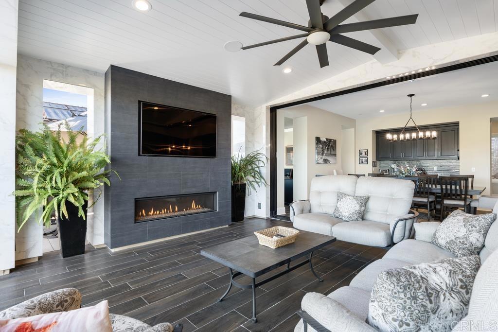 15433 Artesian Ridge San Diego, CA 92127 - Photo 6 of 20 a living room with furniture a flat screen tv and a fireplace
