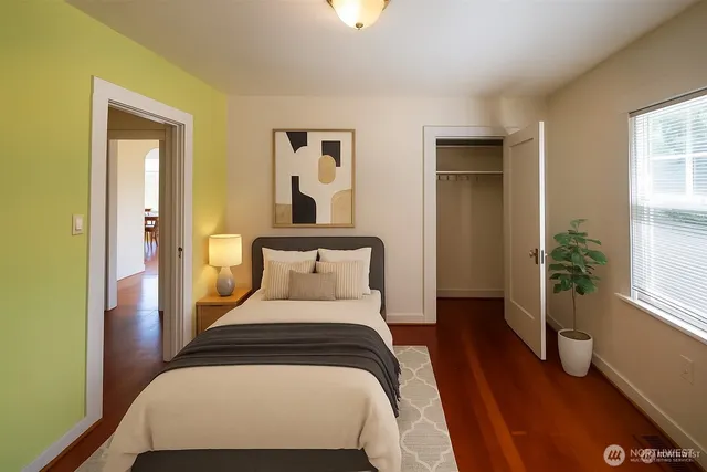 a bedroom with a bed and a potted plant