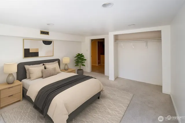 a bedroom with a bed and mirror