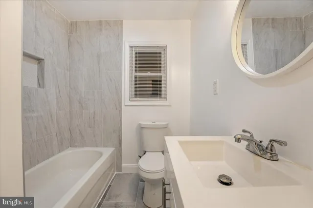 a bathroom with a sink a toilet and a bathtub