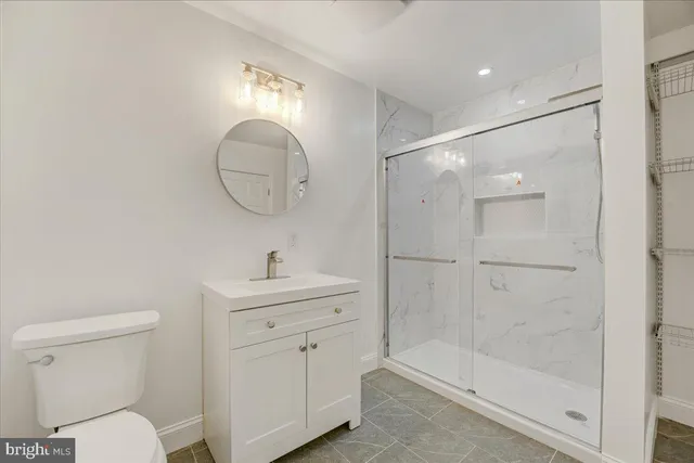 a bathroom with a toilet a sink a mirror and vanity