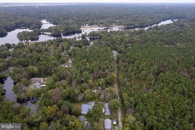 an aerial view of house with yard and mountain view in back