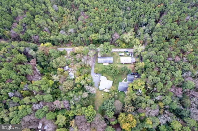 an aerial view of a house with a yard and lake view