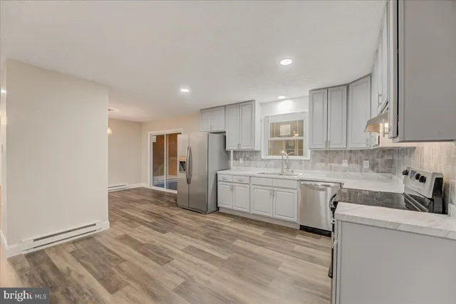 a kitchen with refrigerator cabinets and a sink