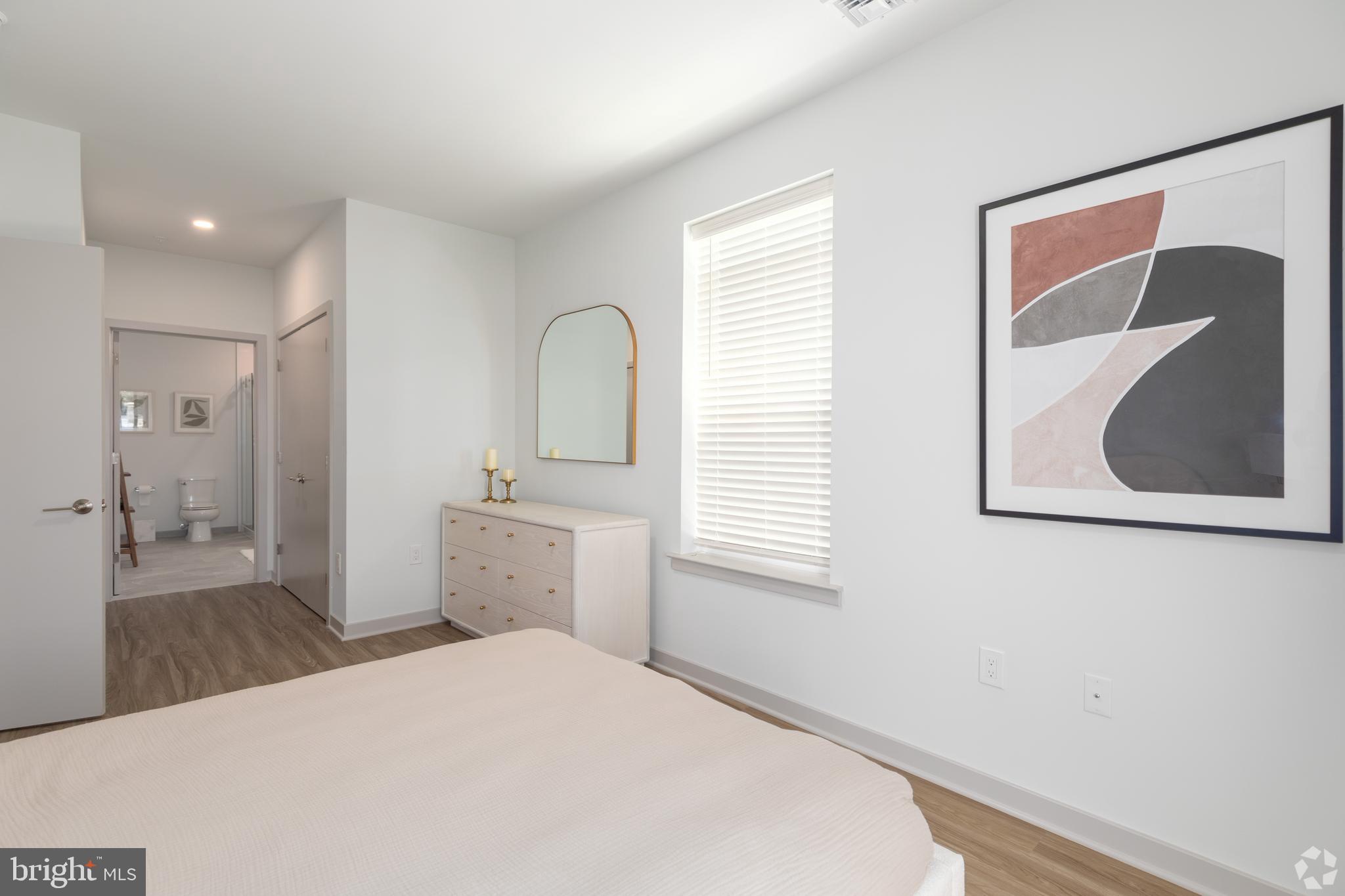 6461 Highway 9, Unit 443 Howell, NJ 07731 - Photo 12 of 26 a bedroom with a bed and a painting on the wall