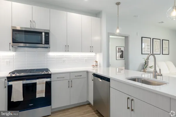 a kitchen with stainless steel appliances granite countertop a sink and refrigerator
