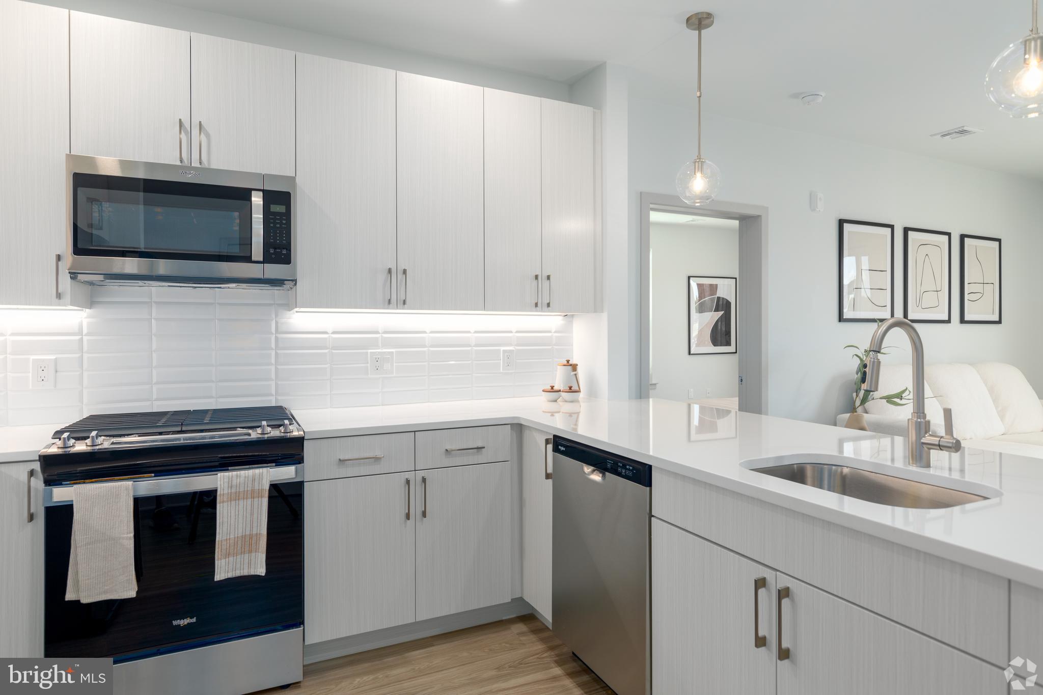 6461 Highway 9, Unit 443 Howell, NJ 07731 - Photo 9 of 26 a kitchen with a sink stove and microwave