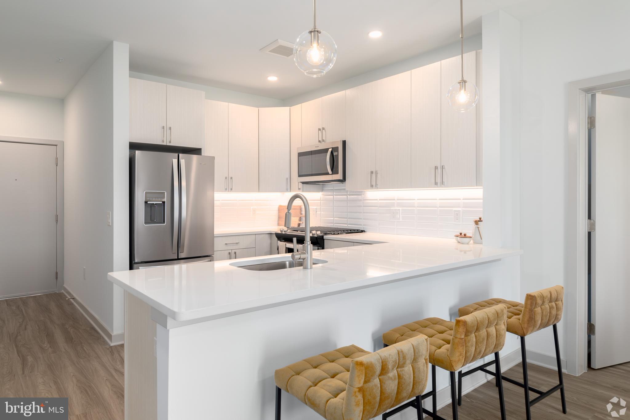 6461 Highway 9, Unit 443 Howell, NJ 07731 - Photo 10 of 26 a kitchen with stainless steel appliances granite countertop a sink and refrigerator